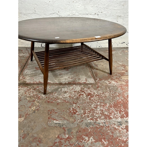 175 - An Ercol elm and beech oval two tier coffee table - approx. 44cm high x 82cm wide x 100cm long