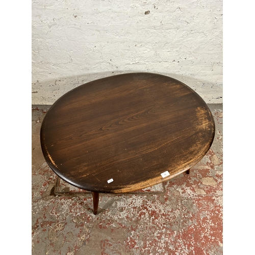 175 - An Ercol elm and beech oval two tier coffee table - approx. 44cm high x 82cm wide x 100cm long