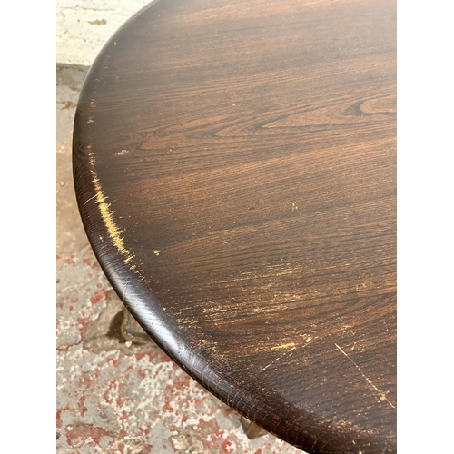 175 - An Ercol elm and beech oval two tier coffee table - approx. 44cm high x 82cm wide x 100cm long