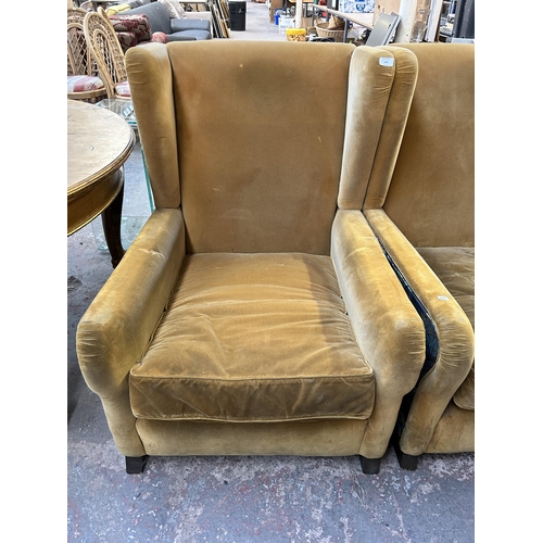 178 - A pair of mid 20th century yellow fabric upholstered wingback armchairs