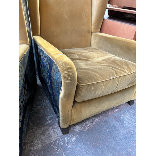 178 - A pair of mid 20th century yellow fabric upholstered wingback armchairs