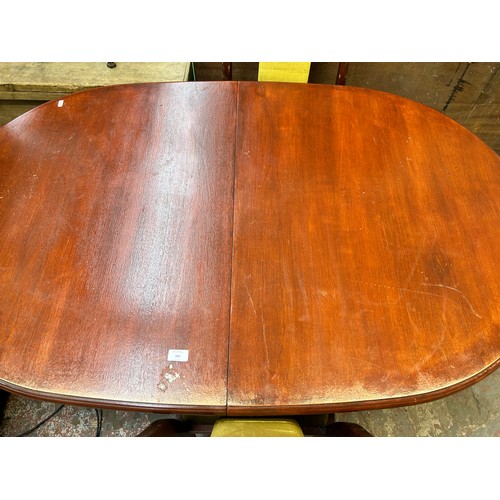 103 - A mahogany extending dining table and four matching chairs