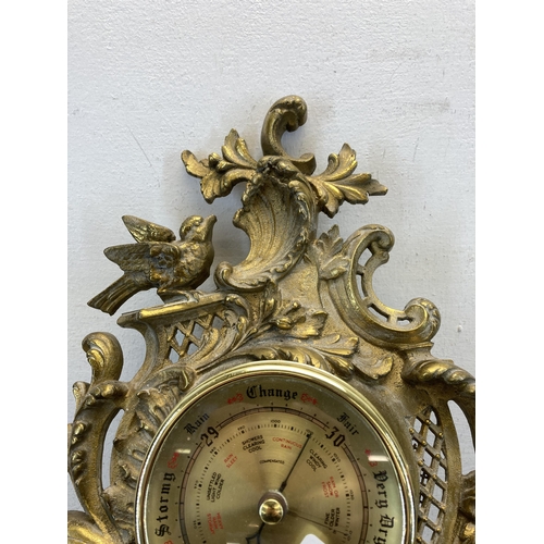 435 - A Rococo style gilded cast metal wall mountable barometer - approx. 50cm long