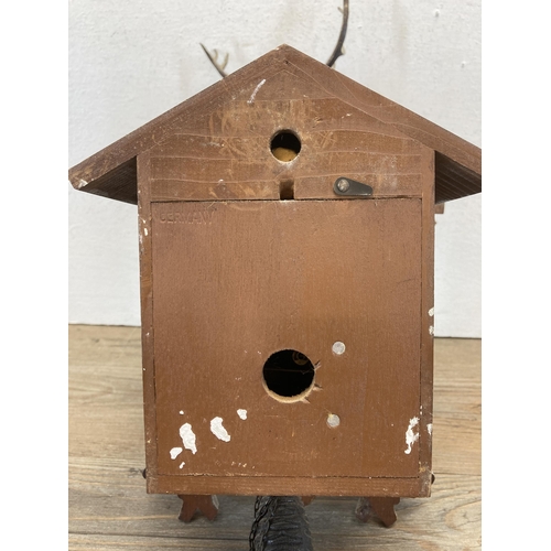 442 - A hardwood wall mountable cuckoo clock with two weights and pendulum - approx. 36cm high