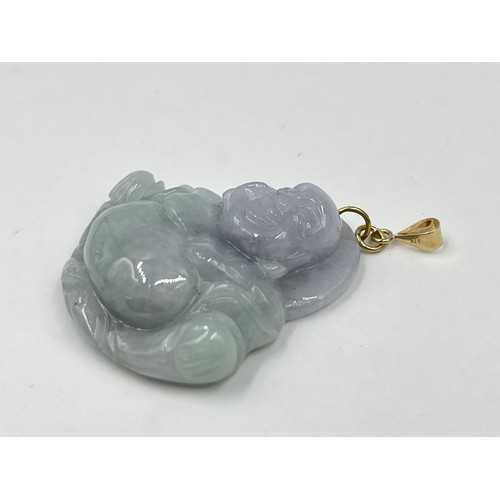 1243 - A carved jade buddha pendant with 9ct gold bail - approx. gross weight 15.77 grams