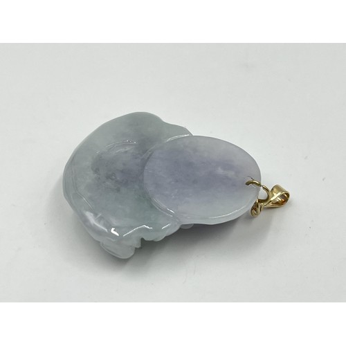 1243 - A carved jade buddha pendant with 9ct gold bail - approx. gross weight 15.77 grams