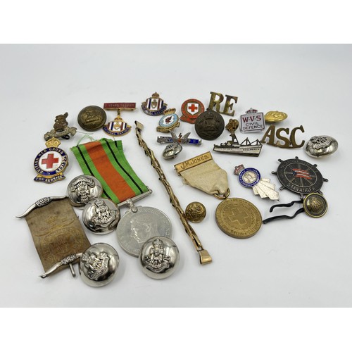 1360 - A collection of medals, badges and buttons to include WWII Defence medal, The British Red Cross Soci... 