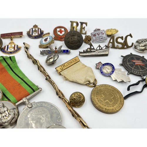 1360 - A collection of medals, badges and buttons to include WWII Defence medal, The British Red Cross Soci... 