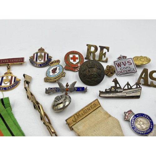 1360 - A collection of medals, badges and buttons to include WWII Defence medal, The British Red Cross Soci... 