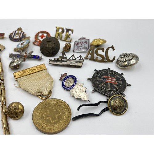 1360 - A collection of medals, badges and buttons to include WWII Defence medal, The British Red Cross Soci... 