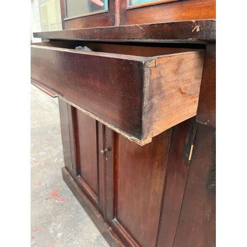 25 - A Victorian mahogany bookcase with two upper glazed doors, single drawer and two lower cupboard door... 