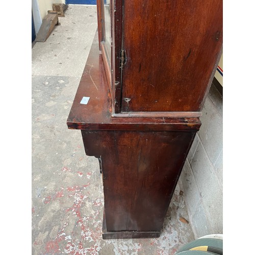 25 - A Victorian mahogany bookcase with two upper glazed doors, single drawer and two lower cupboard door... 