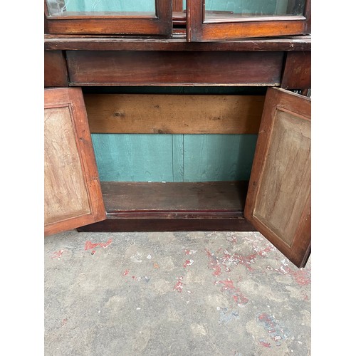 25 - A Victorian mahogany bookcase with two upper glazed doors, single drawer and two lower cupboard door... 