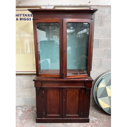 25 - A Victorian mahogany bookcase with two upper glazed doors, single drawer and two lower cupboard door... 