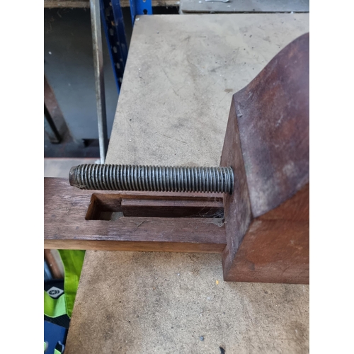 790 - A vintage wooden table mounted bench vice