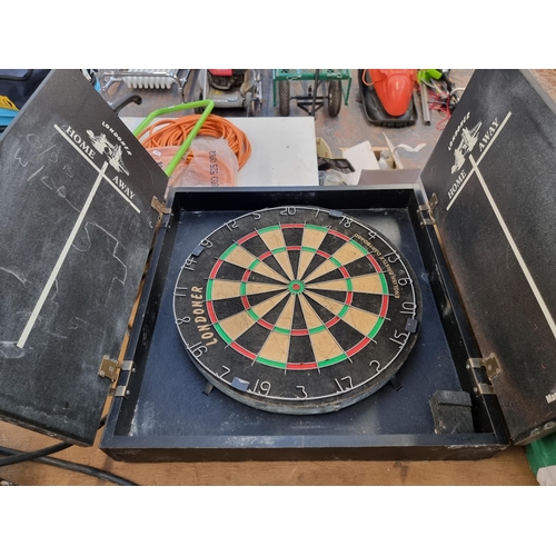 811 - A cased Nodor Londoner dartboard - approx. 57cm high x 57cm wide x 9cm deep