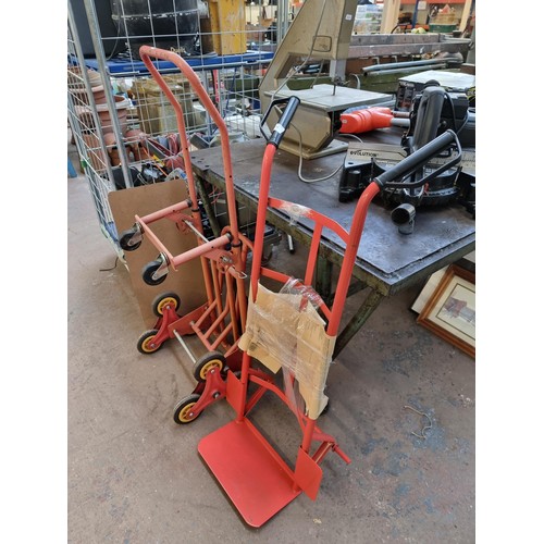 834 - Two red metal sack trucks