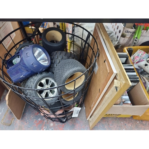 900 - Three boxes and one basket containing pictures, ceramics, gilt framed wall mirror, remote control mo... 