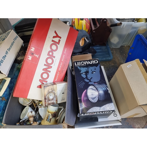 905 - A large quantity of house clearance items to include Monopoly board game, cast metal and green glass... 