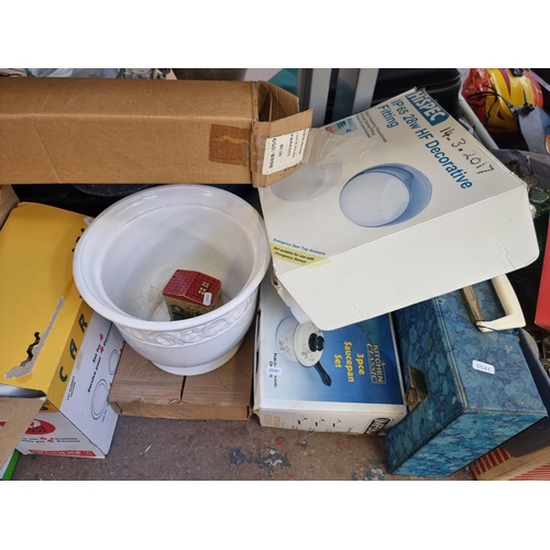 905 - A large quantity of house clearance items to include Monopoly board game, cast metal and green glass... 