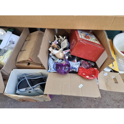 905 - A large quantity of house clearance items to include Monopoly board game, cast metal and green glass... 