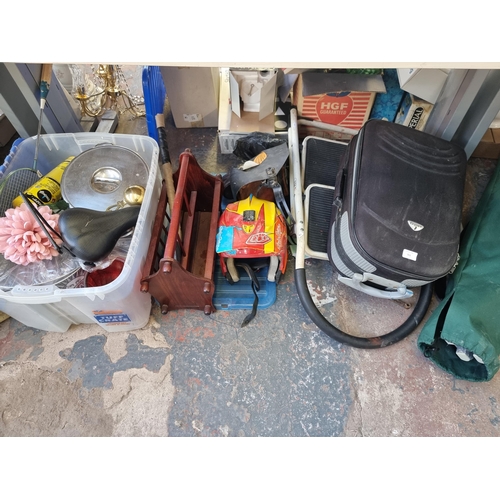 911 - A large collection of house clearance items to include brass oil lamps, step ladders, magazine rack,... 