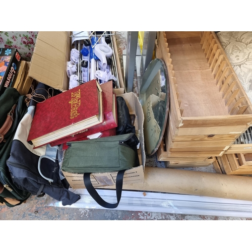 911 - A large collection of house clearance items to include brass oil lamps, step ladders, magazine rack,... 