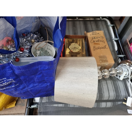 923 - Three bags containing household items to include Hermle mahogany and brass effect mantel clock etc. ... 