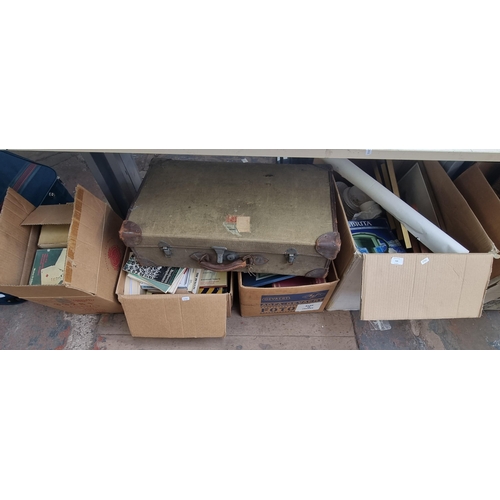 928 - Four boxes containing books, ceramics, pictures, vintage canvas suitcase etc.