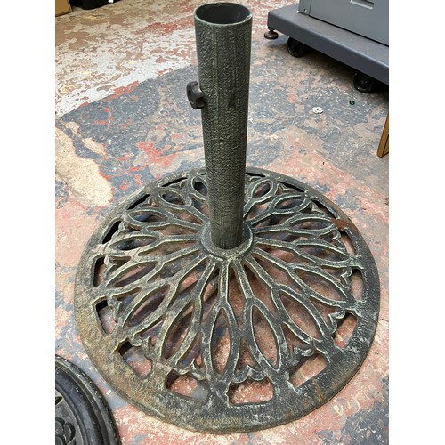 888 - Two cast metal garden parasol bases