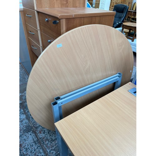 115 - Two modern beech effect and grey metal office desks, one circular - approx. 120cm diameter x 73cm hi... 