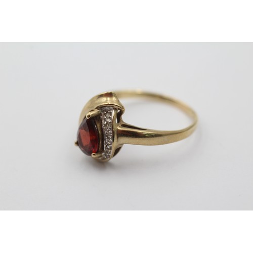 1001 - A 9ct gold teardrop garnet solitaire ring with diamond accents, size R - approx. gross weight 2.4 gr... 