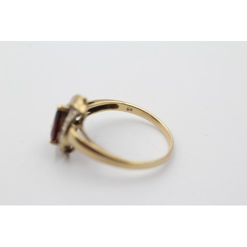 1001 - A 9ct gold teardrop garnet solitaire ring with diamond accents, size R - approx. gross weight 2.4 gr... 