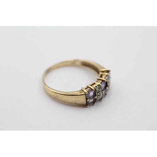 1006 - A 9ct gold tanzanite two row ring with diamond spacers, size S - approx. gross weight 2.7 grams