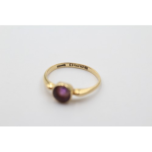 1012 - An 18ct gold round cut amethyst solitaire ring, size N - approx. gross weight 2.5 grams