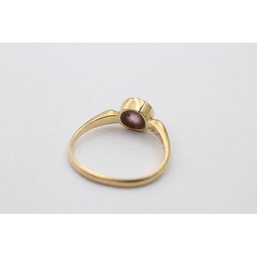 1012 - An 18ct gold round cut amethyst solitaire ring, size N - approx. gross weight 2.5 grams