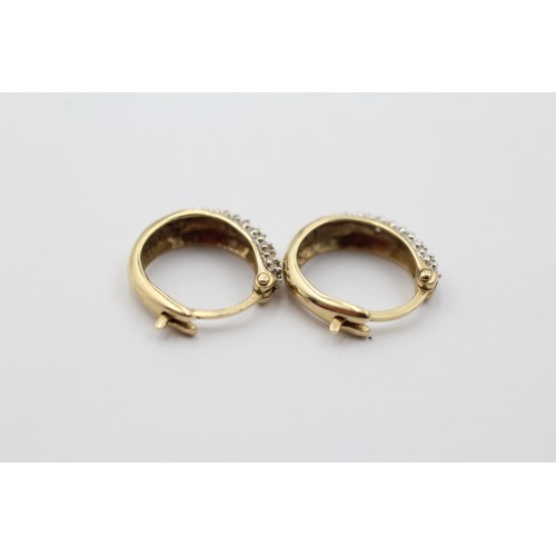 1016 - A pair of 9ct gold diamond hoop earrings - approx. gross weight 1.9 grams