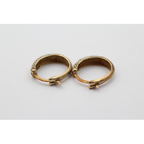 1017 - A pair of 9ct gold diamond hoop earrings - approx. gross weight 1.9 grams