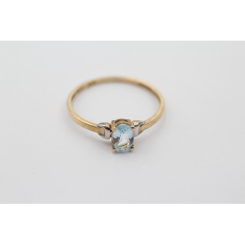 1018 - A 9ct gold oval cut topaz solitaire ring, size P - approx. gross weight 0.9 grams