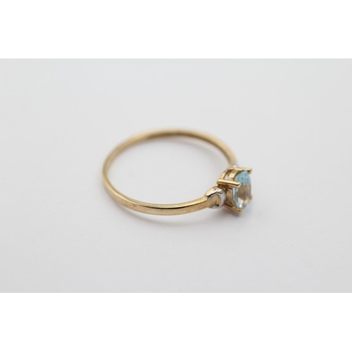 1018 - A 9ct gold oval cut topaz solitaire ring, size P - approx. gross weight 0.9 grams