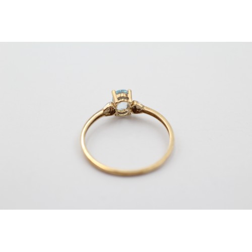 1018 - A 9ct gold oval cut topaz solitaire ring, size P - approx. gross weight 0.9 grams