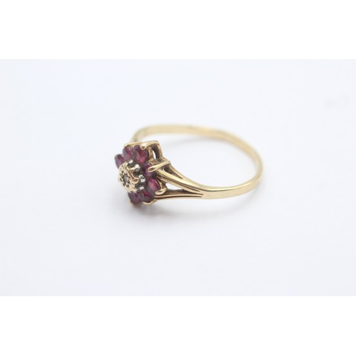 1019 - A 9ct gold diamond and ruby dress ring, size M - approx. gross weight 1.9 grams