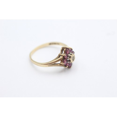 1019 - A 9ct gold diamond and ruby dress ring, size M - approx. gross weight 1.9 grams