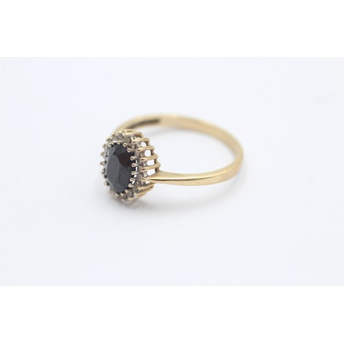 1020 - A 9ct gold diamond and sapphire halo ring, size Q - approx. gross weight 2 grams