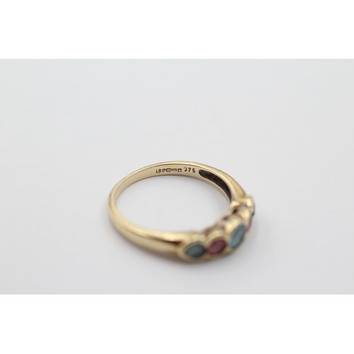 1034 - A 9ct gold topaz and pink gemstone five stone ring, size M - approx. gross weight 1.8 grams