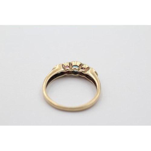 1034 - A 9ct gold topaz and pink gemstone five stone ring, size M - approx. gross weight 1.8 grams