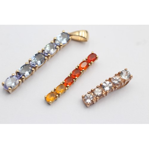 1044 - Three 9ct gold gemstone set pendants, one tanzanite, one goshenite and one fire opal - approx. gross... 