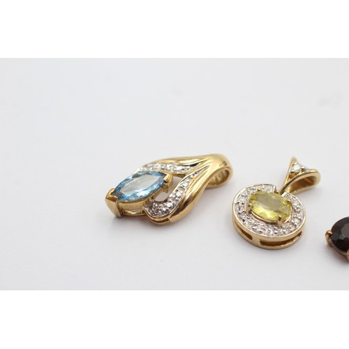 1047 - Four 9ct gold gemstone set pendants, one diamond and garnet, one diamond and yellow gemstone, one di... 