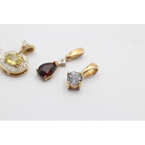 1047 - Four 9ct gold gemstone set pendants, one diamond and garnet, one diamond and yellow gemstone, one di... 