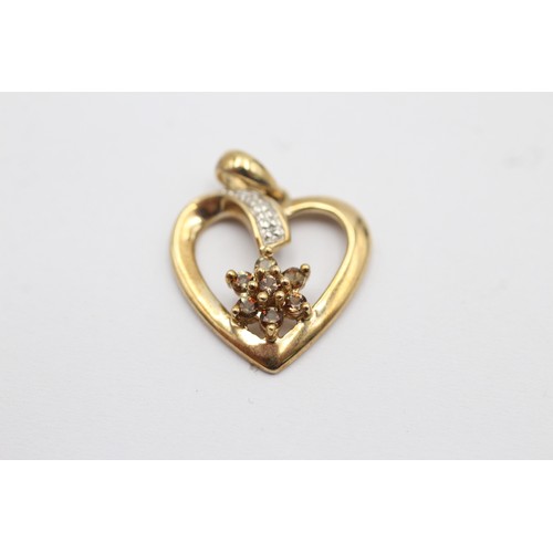 1052 - Two 9ct gold diamond set heart shaped pendants - approx. gross weight 3.9 grams